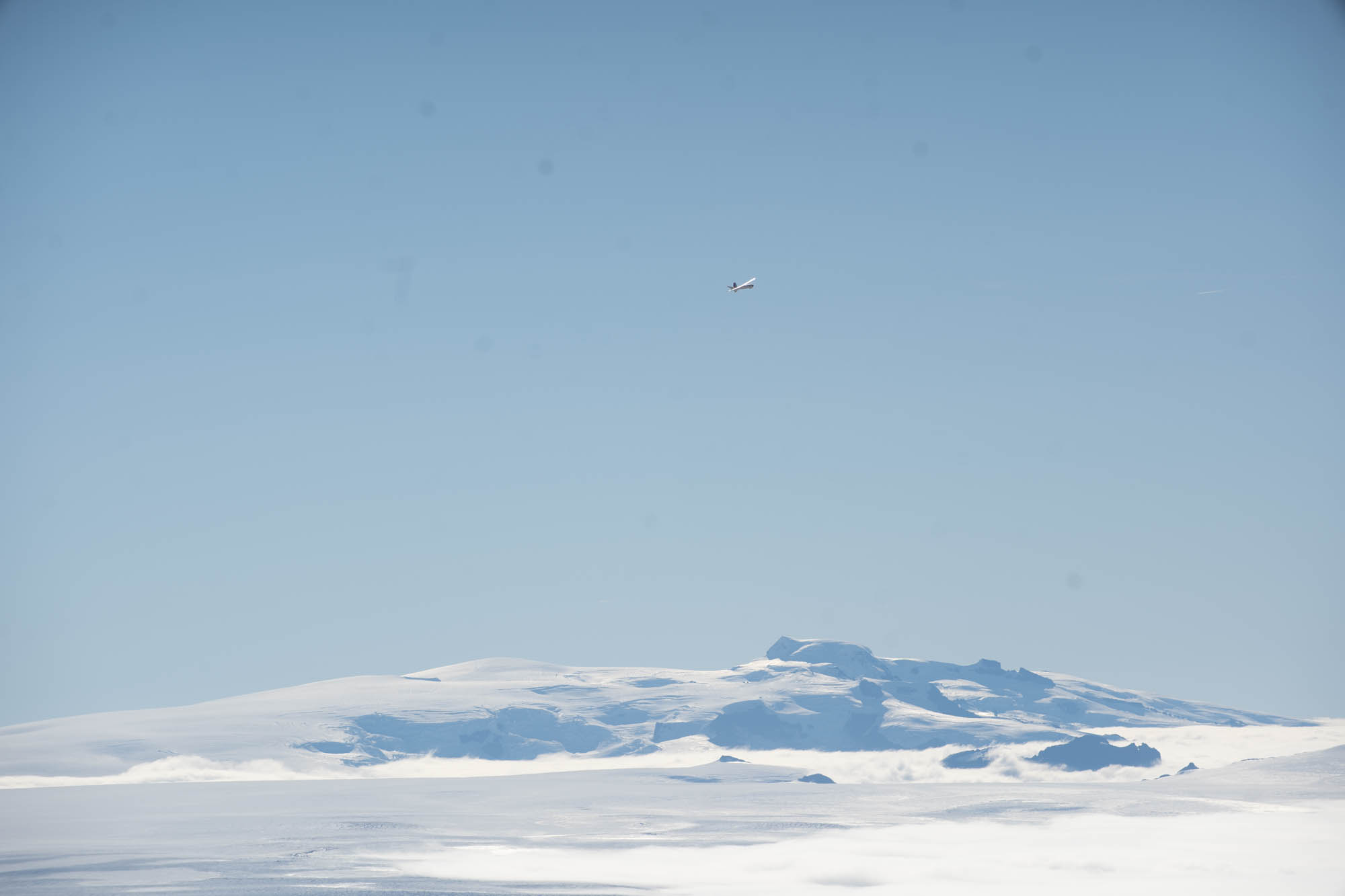 A small survey aircraft flying over the Vatnajökull ice cap in Iceland